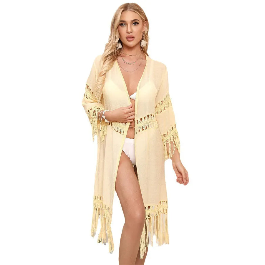 Yellow hand-crocheted acrylic beach cover-up cardigan for women on a hanger.