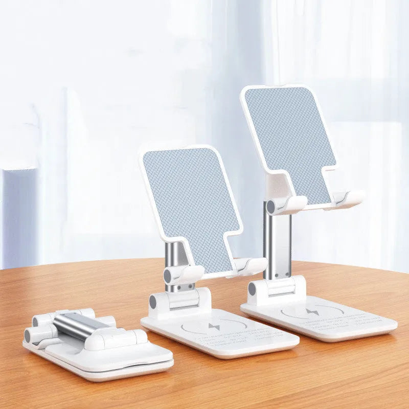 Black and white desktop wireless charging mobile phone holder stand on a desk.