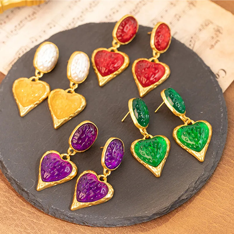 Purple, red, green, and yellow and white alloy pleated oval love heart stud earrings on silver posts.