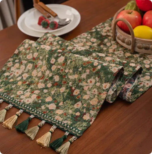 A retro style table flag with handwoven tassels in a blue ginkgo leaf pattern on a table.