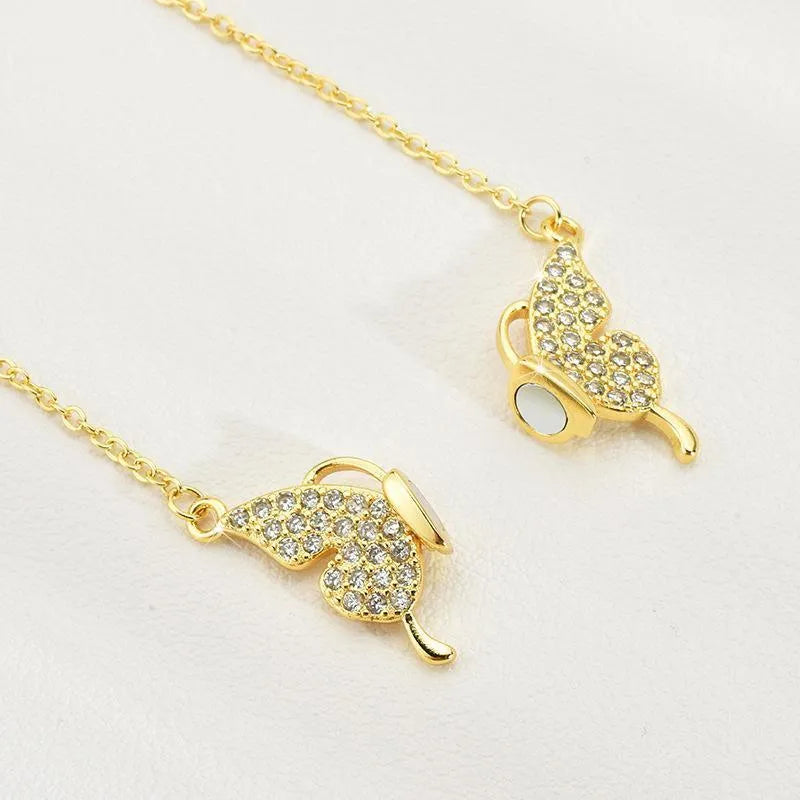Women's magnetic snap butterfly clavicle chain necklace in gold finish showing twisted chain detail