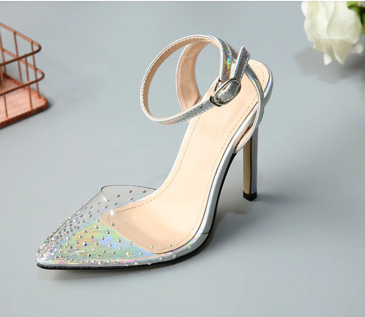 Women's pointed-toe stiletto sandals with a clear PVC upper.