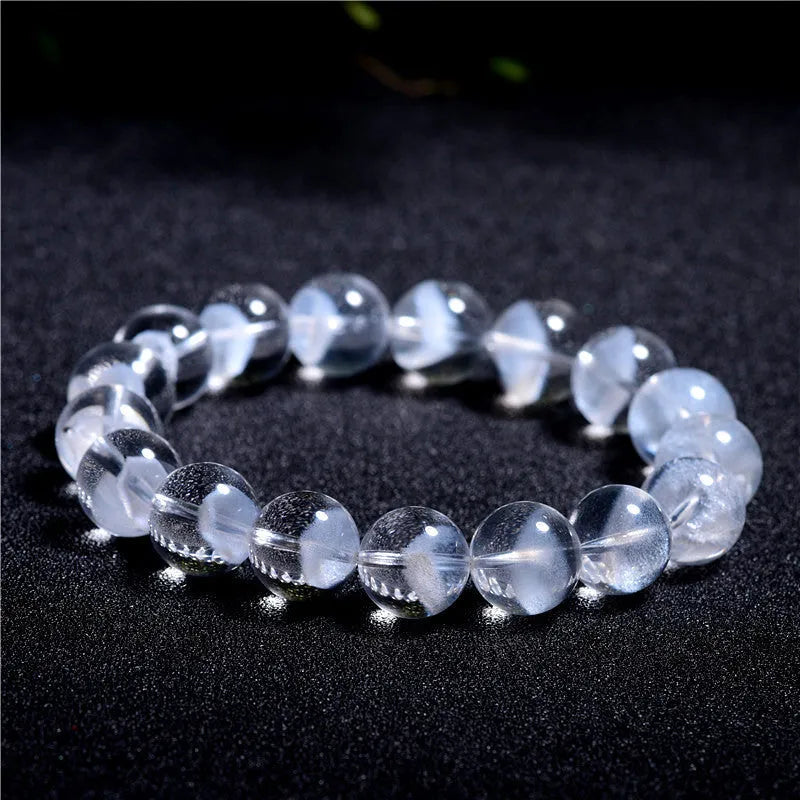 Women's white crystal ghost pyramid bracelet with Ruyi design element showing multiple purity size options