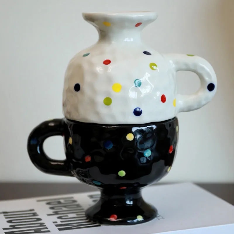 Hand-pinched irregular shaped ceramic mug in a solid colour on a plain background.