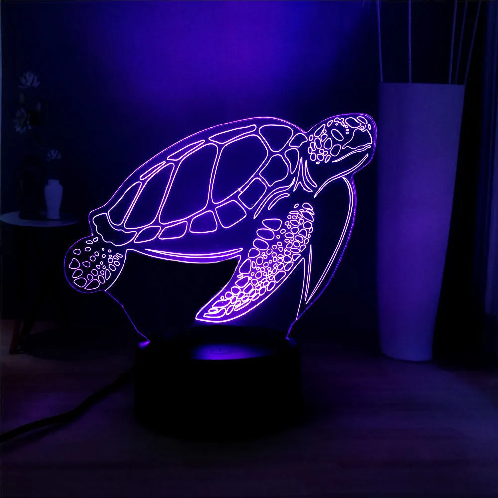Turtle-shaped acrylic night light with multi-coloured 3D LED glow, showing remote control.