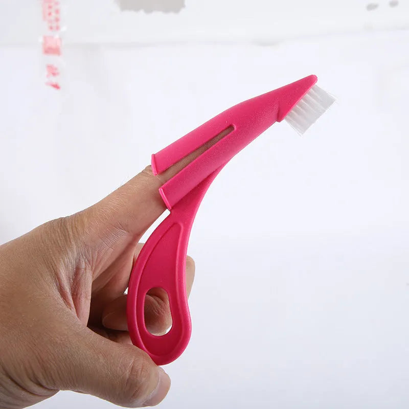 Red and white finger-sleeve toothbrush for cleaning dog and cat teeth, with soft silicone bristles.