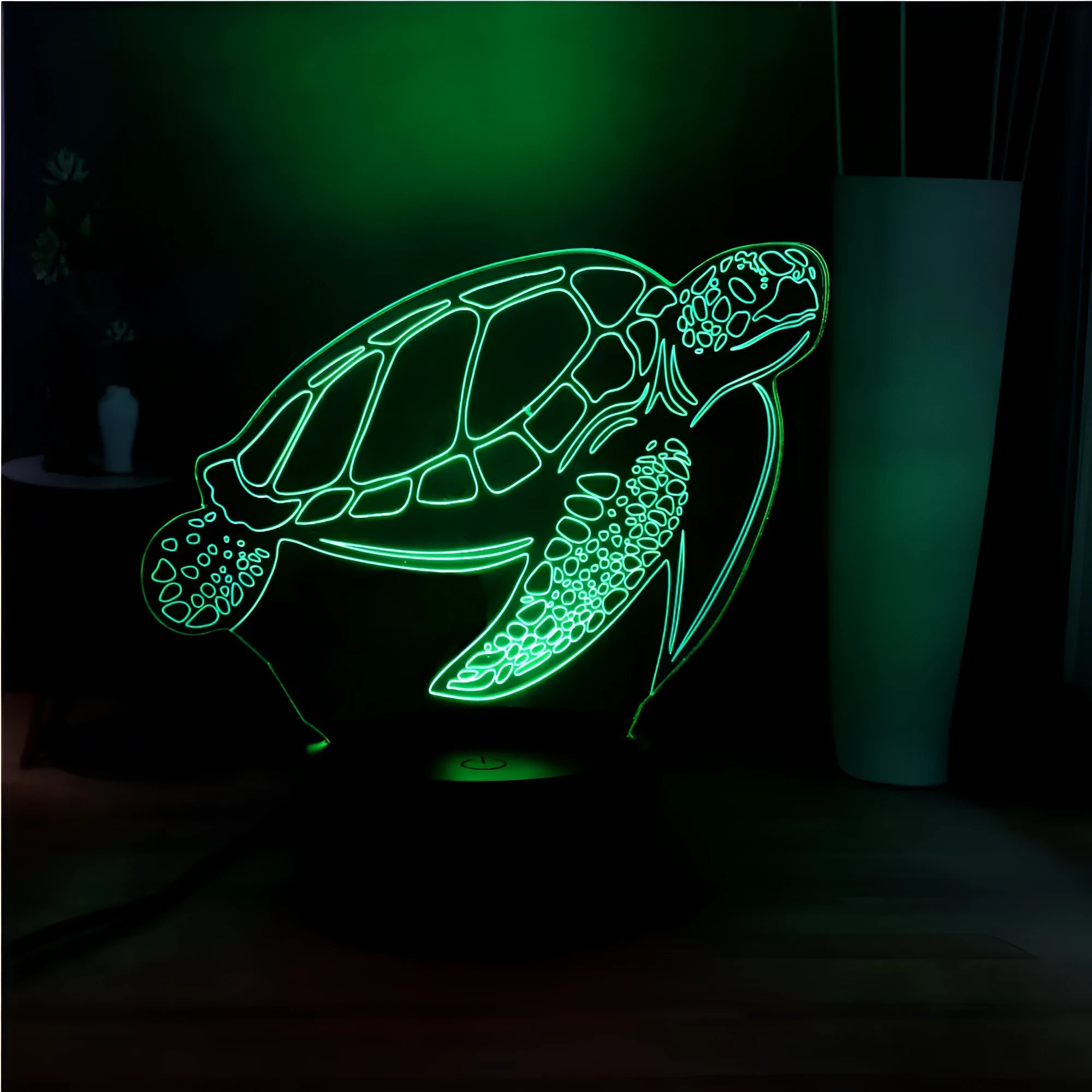 Turtle-shaped acrylic night light with multi-coloured 3D LED glow, showing remote control.