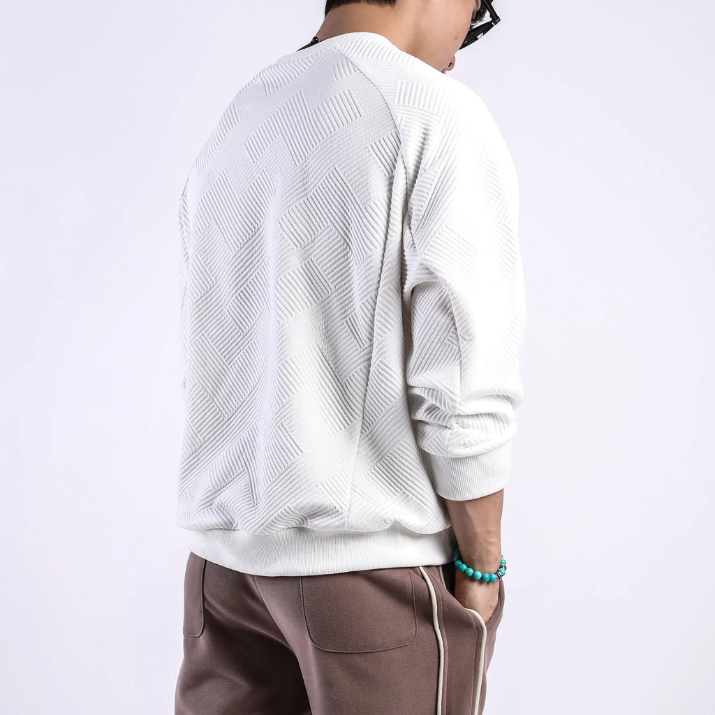 Man wearing a loose fit Army Green twill jacquard long sleeve pullover sweater.