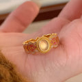 Geometric open mouth women's ring with pink crystal enamel on gold-plated copper.
