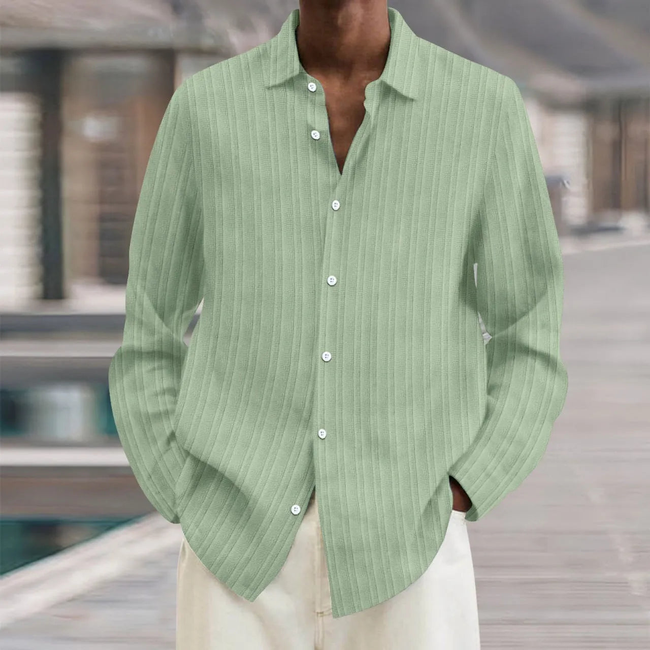 Man wearing a loose-fit, striped, long-sleeve cardigan in a blue colour variant
