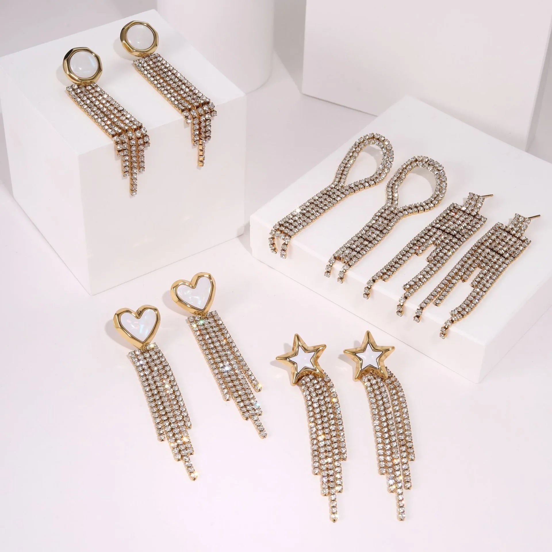 Women's stainless steel drop earrings with heart shape, star charm and diamond tassel detailing in 18K electroplated finish