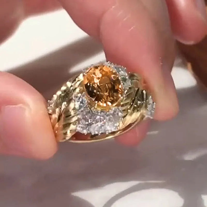 Gold-coloured copper feather ring with geometric design and yellow zircon inlay details
