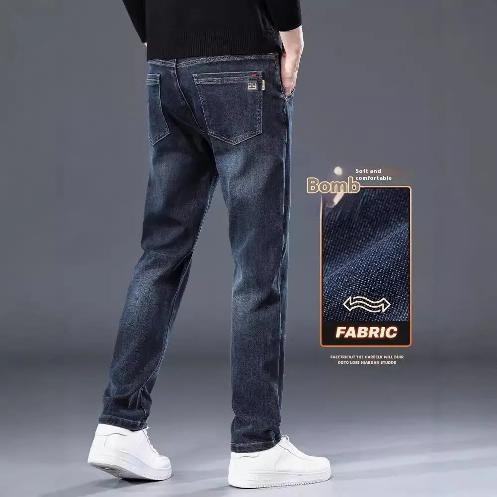 Man wearing slim straight blue-grey casual trousers with a micro-elastic fit and zipper fly.