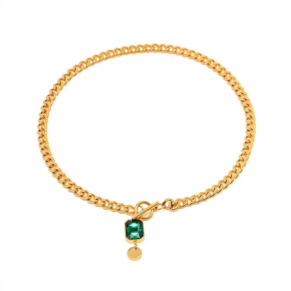 Gold electroplated geometric round pendant necklace with Cuban link chain and emerald zircon detail