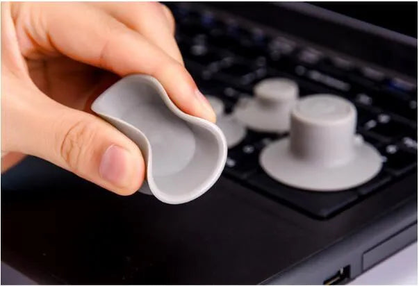 Set of four grey durable plastic laptop cooling pads, two large and two small, on a flat surface.