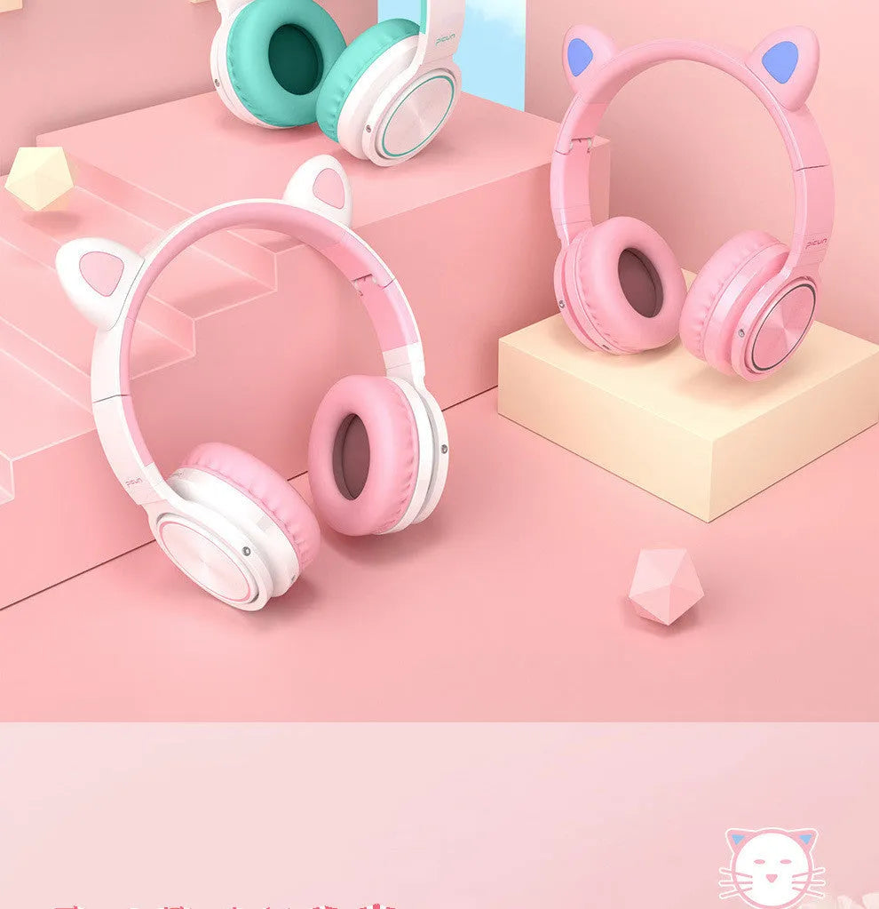 Pink and white wireless Bluetooth headphones with head-mounted design and braided cable