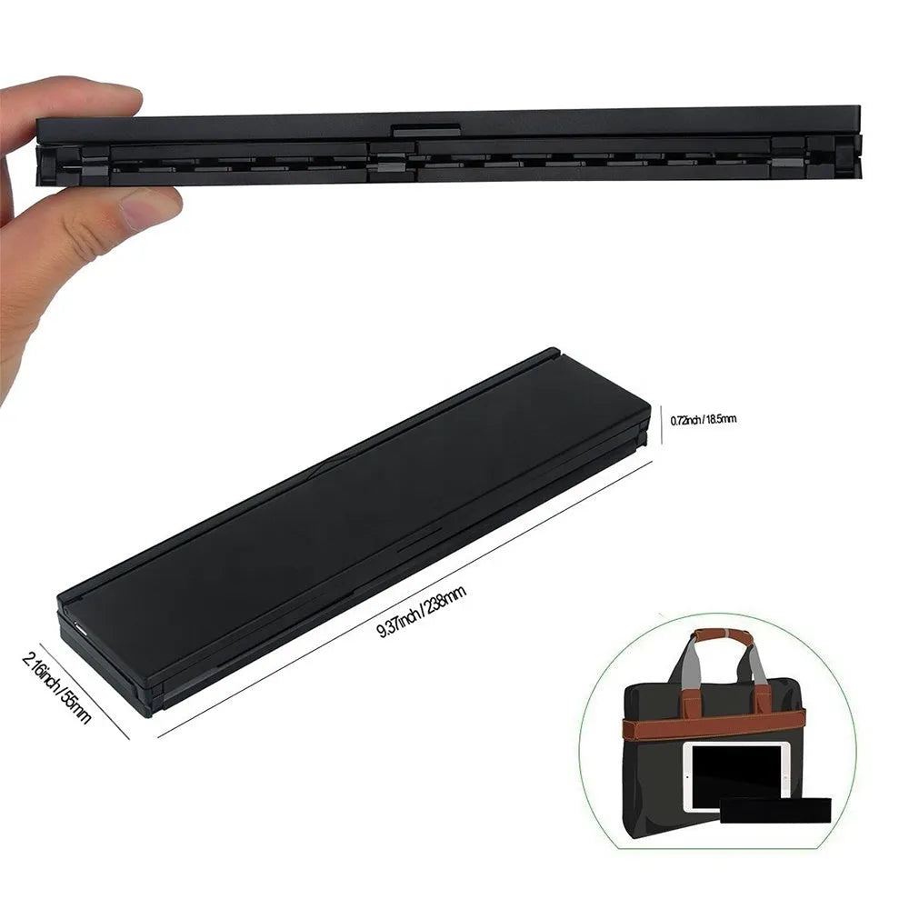 Black folding Bluetooth keyboard with numeric pad next to tablet