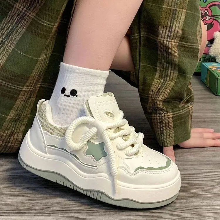 Women's green platform sneakers with patent leather finish and round toe front lace-up design
