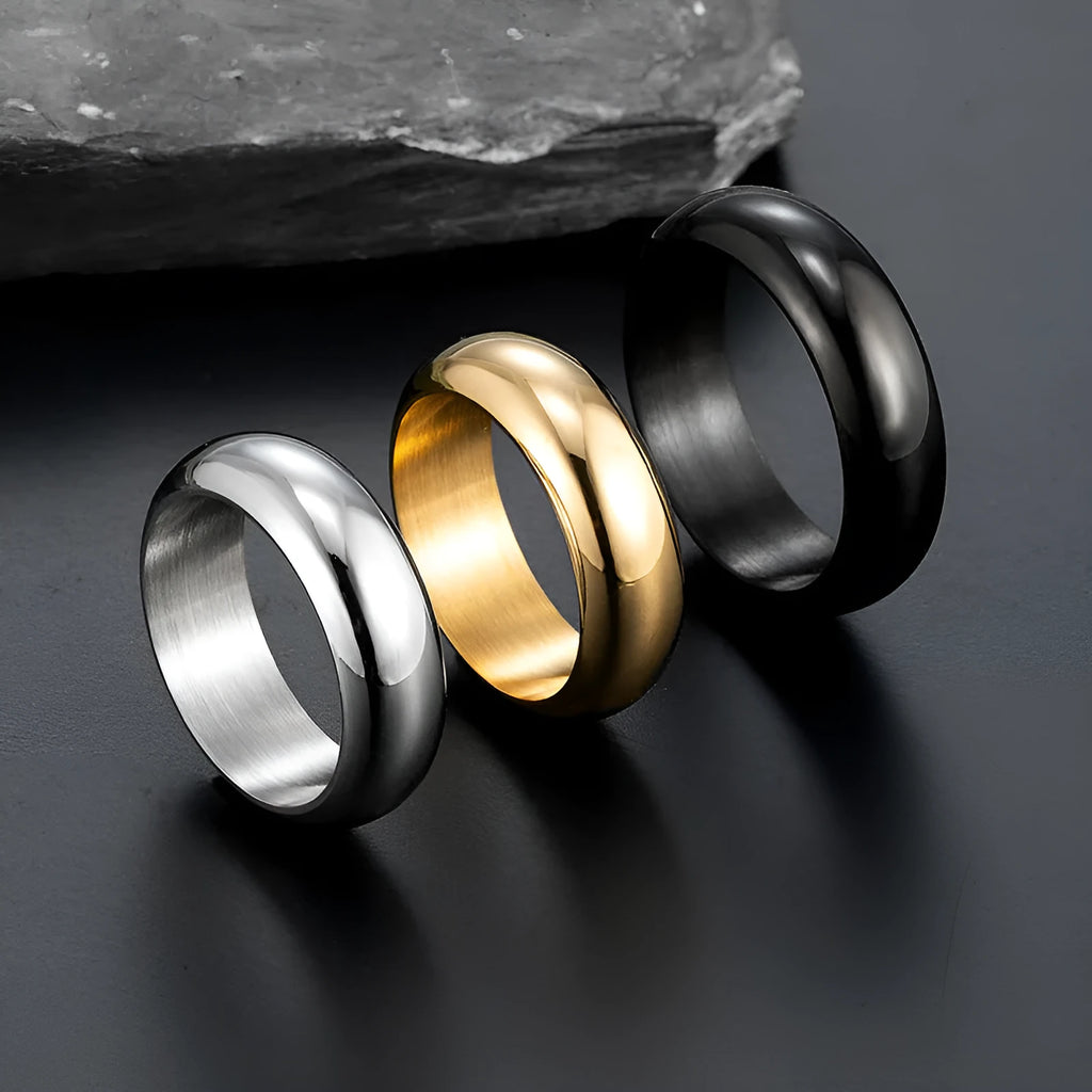 Glossy electroplated titanium steel ring shown in gold, black, and steel colour on a grey background.