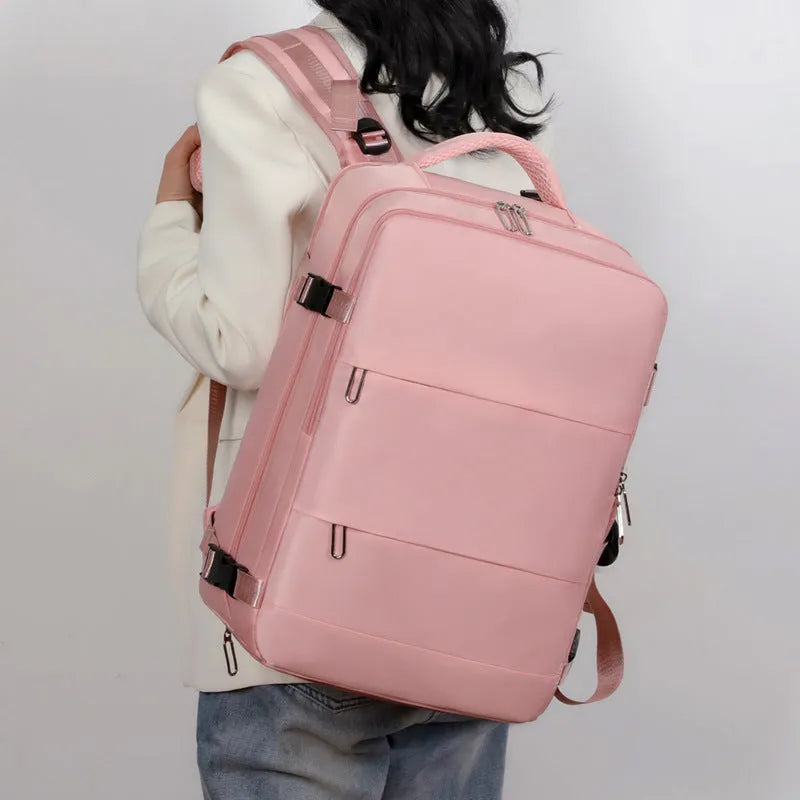 Large purple travel backpack for women with laptop compartment and organisational pockets.