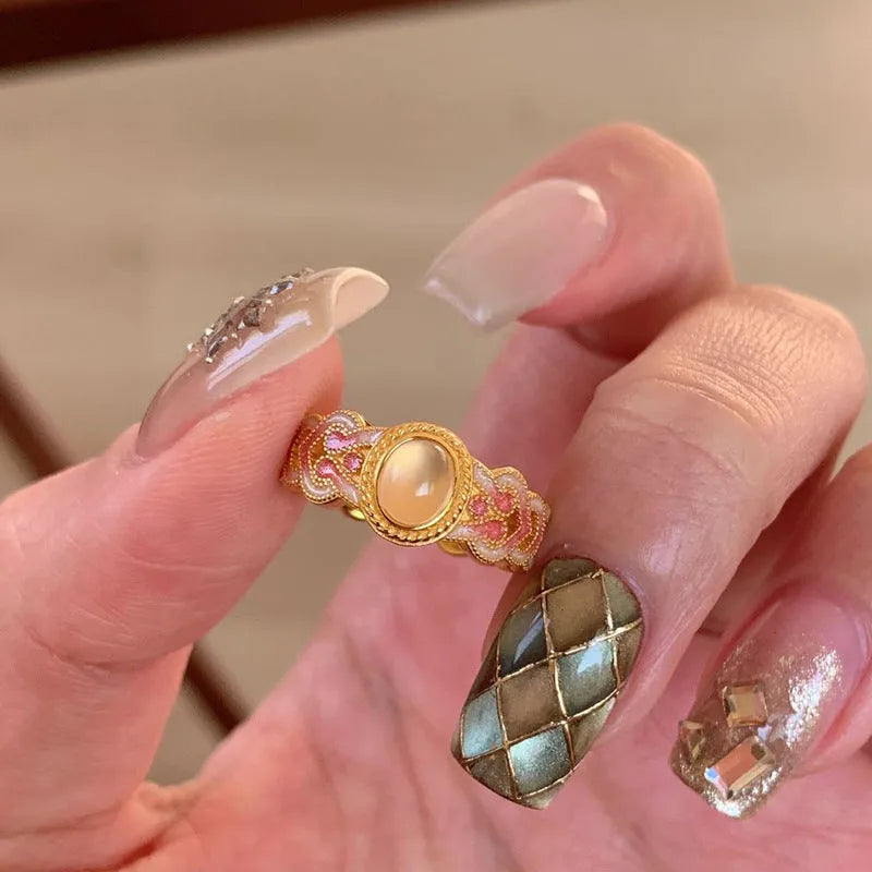 Geometric open mouth women's ring with pink crystal enamel on gold-plated copper.