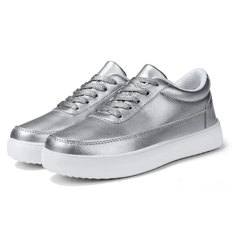Women's gold leather lace-up casual flat shoes on a white background, showing front and side views.