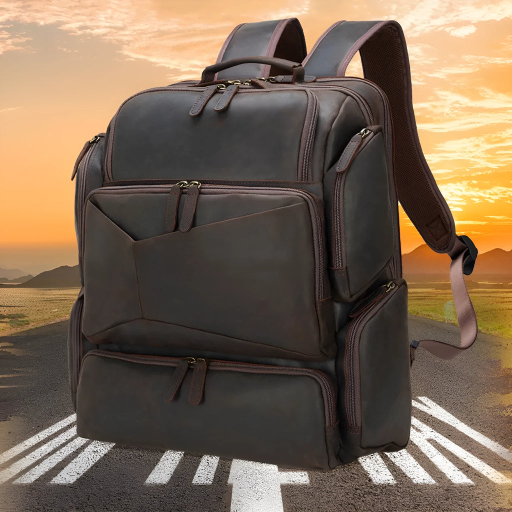 Dark brown leather backpack for 17-inch laptops with multiple compartments and shoulder straps