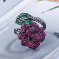 Gold-plated geometric flower ring with red simulated corundum stone on black gold finish