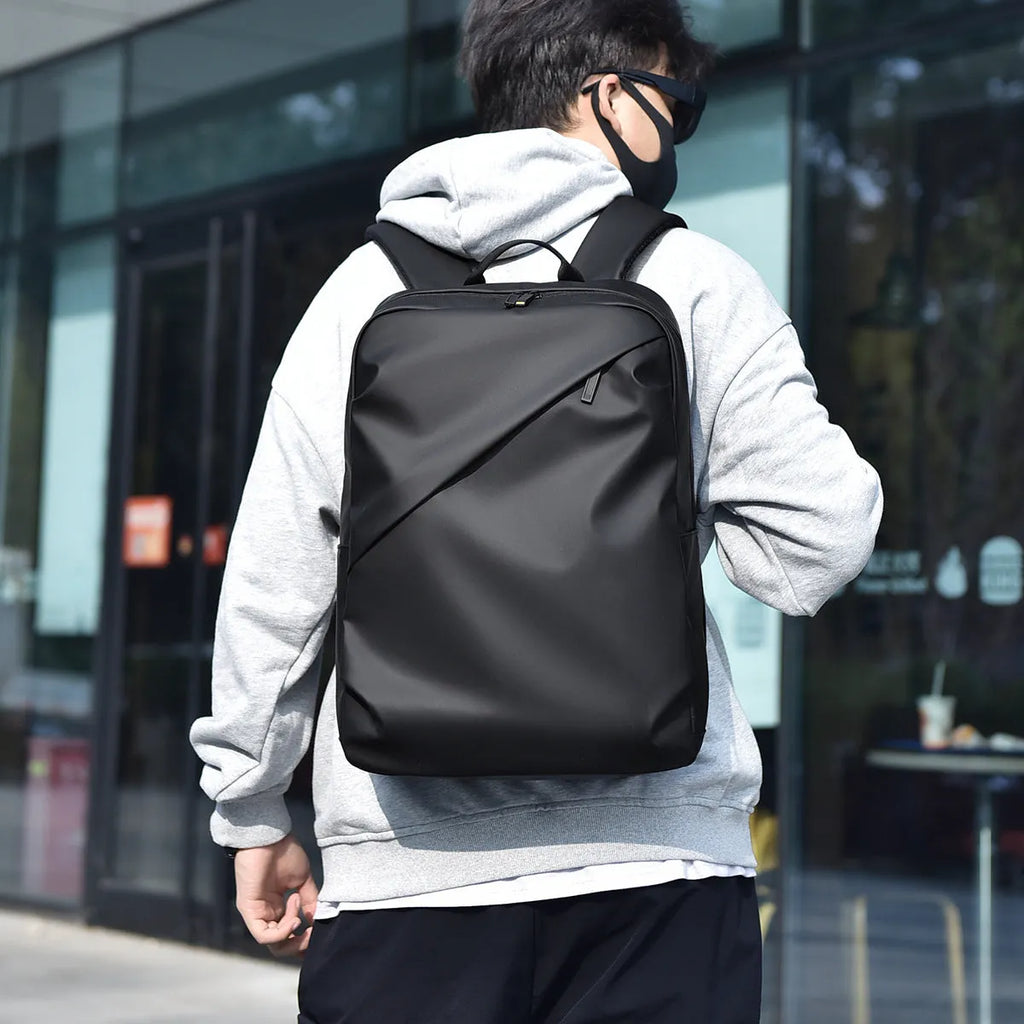 Large black waterproof PU leather backpack with sewing thread detail, shown from a side angle.