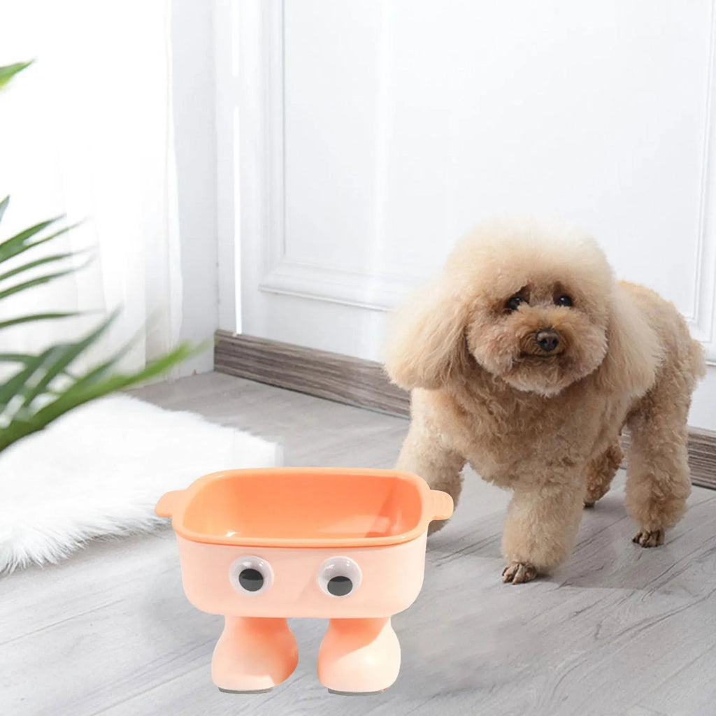 Green elevated cat bowl with 15-degree tilt, detachable inner dish, and cartoon robot design on a table.