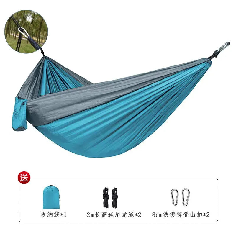 Blue nylon parachute cloth outdoor hammock hanging between trees