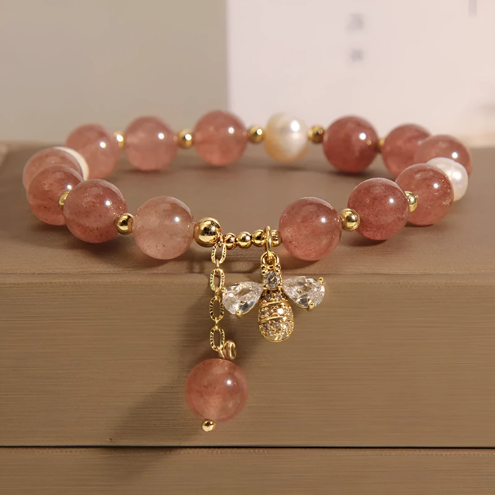 Women's bracelet with freshwater pearls, strawberry quartz beads, zircon accents, and an alloy clasp.