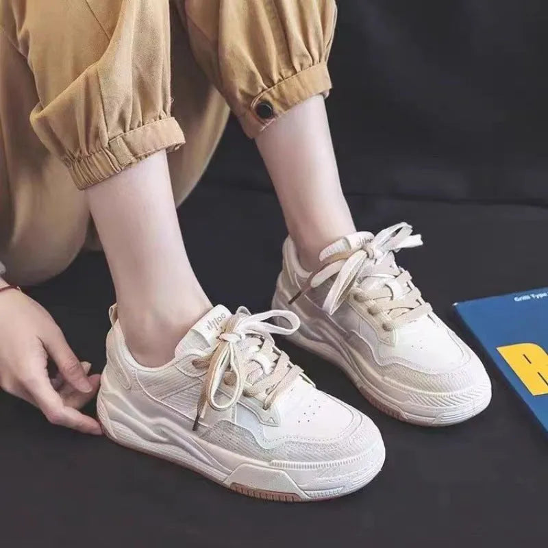 Low-top sneakers with rubber soles in beige and pink colour options showing height-increasing design
