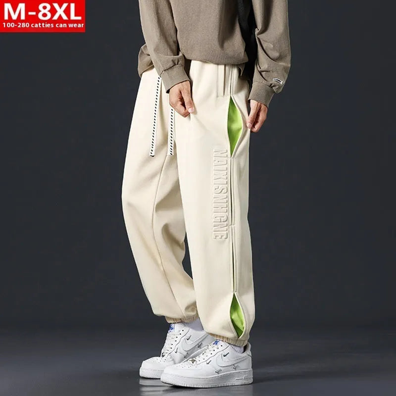 Men's grey green cotton casual trousers with white collage stitching detail and an elasticated ankle band.