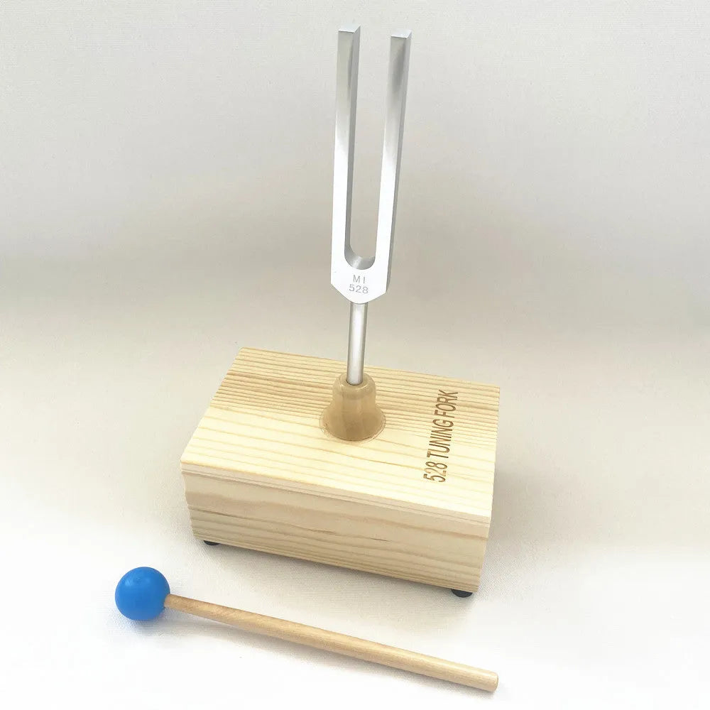 432Hz aluminium tuning fork and small speaker set on kraft paper packaging
