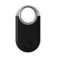Black and white GPS tracker device for pets and children showing USB port and compact size.