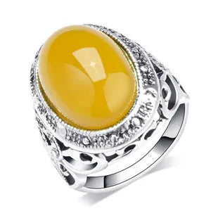 Fluorescent beeswax centre geometric ring in antique silver on a hand.