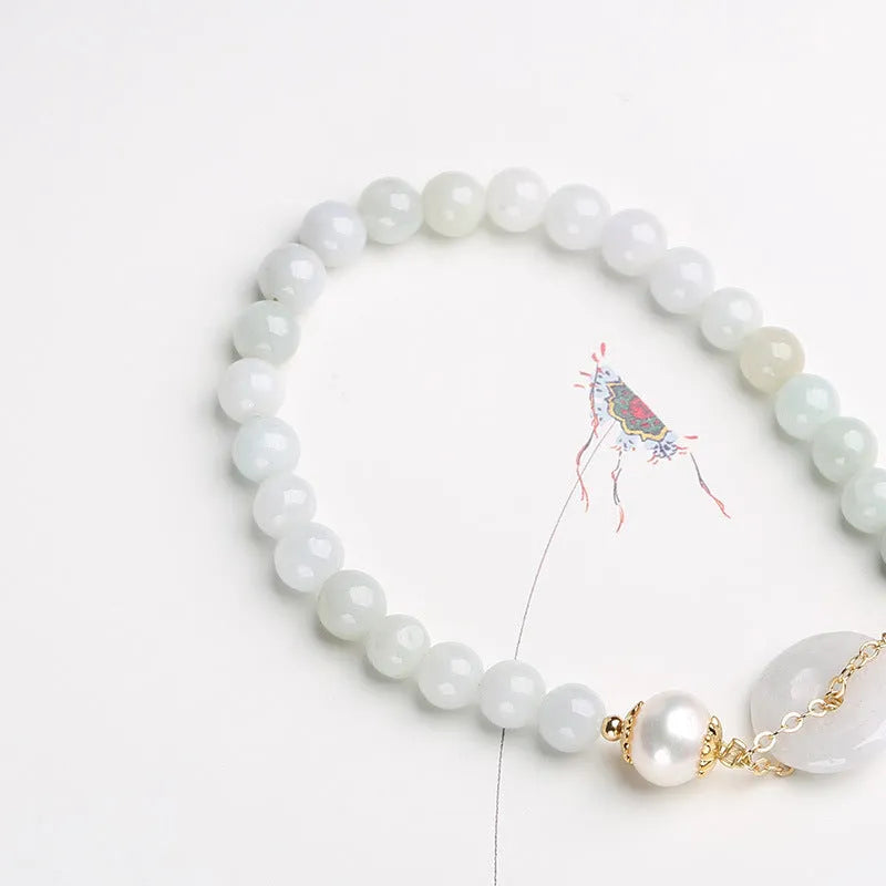 Natural emerald green jade and pearl bracelet with geometric peace buckle closure