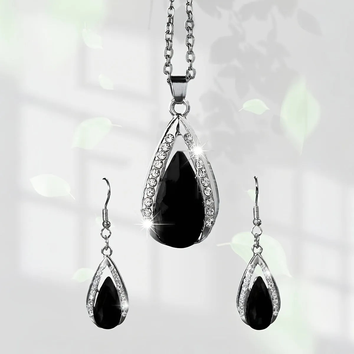 Black and red teardrop glass pendant necklace and matching earrings set on alloy chain.