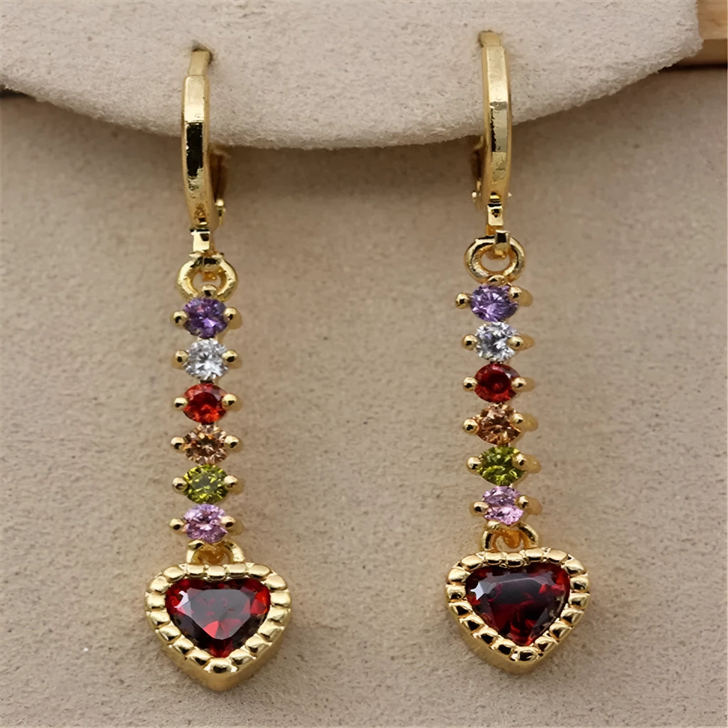 A pair of women's heart-shaped drop earrings with a gold electroplated finish.