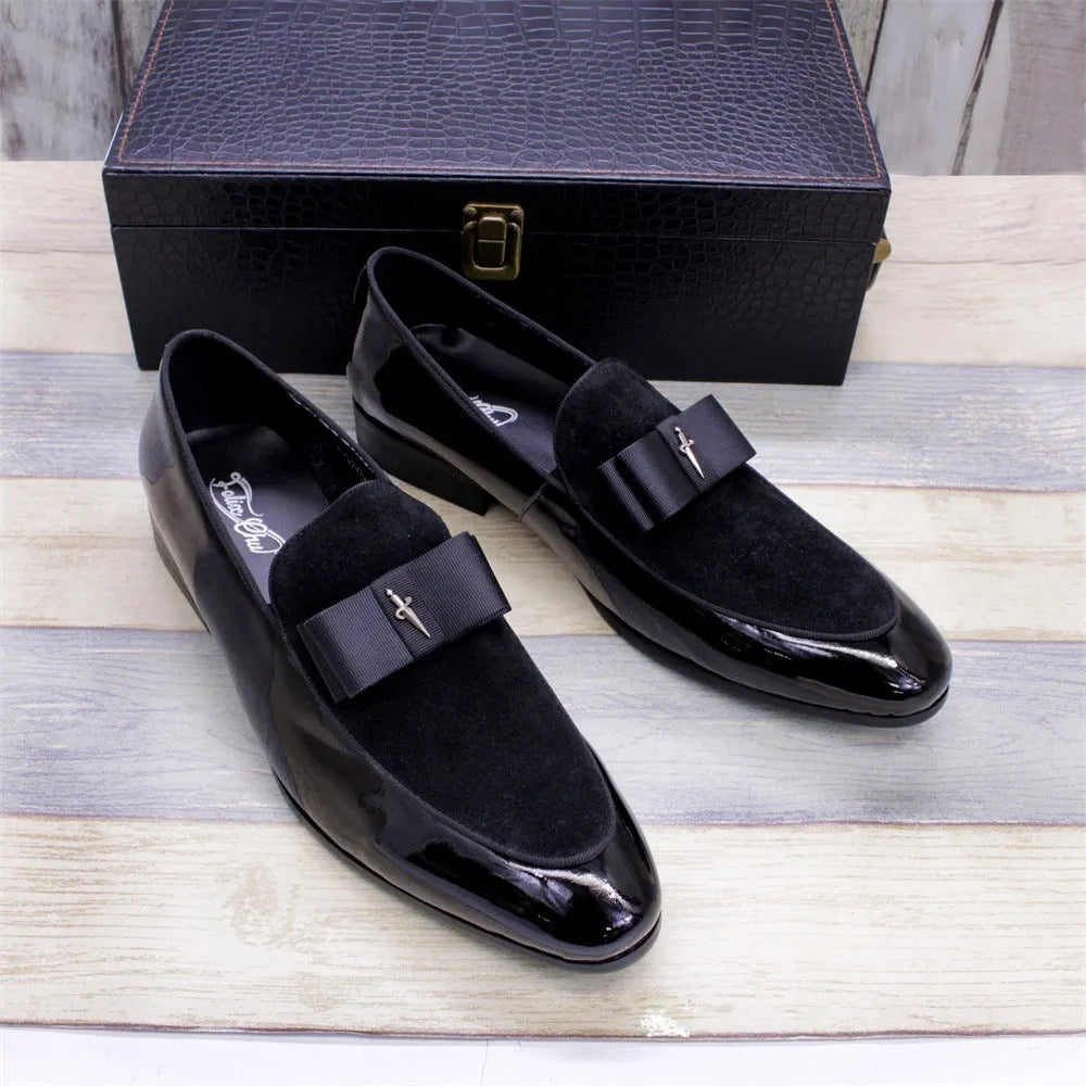 Men's glossy black patent leather low-top shoes with a tassel detail on a rubber sole.