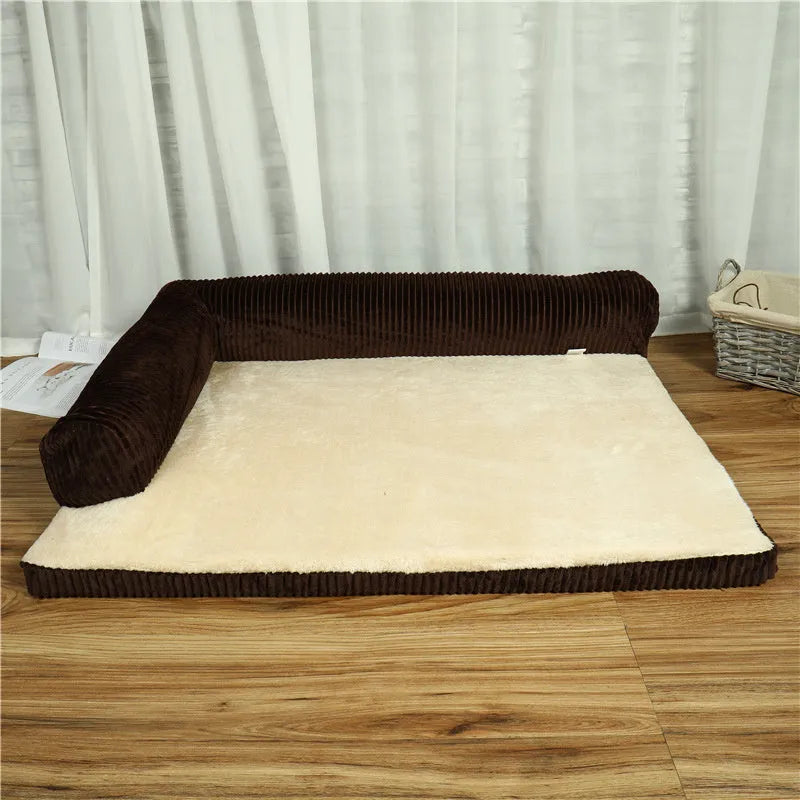 A corduroy dog sofa bed with raised sides, shown in a grey colour, placed on a wooden floor.