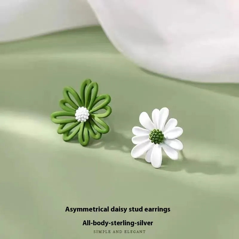A pair of cartoon-style flower stud earrings made from alloy, shown in blue and orange colour contrast.