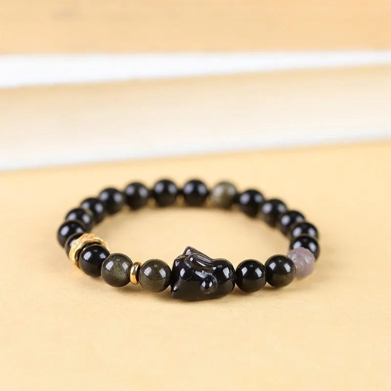 Handmade lying rabbit charm bracelet in Jin Yaoshi or Silver Yaoshi with 8mm or 10mm beads and grey agate accents.