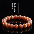 Natural old mine rhodochrosite round bead bracelet with Ruyi symbol on a wrist.