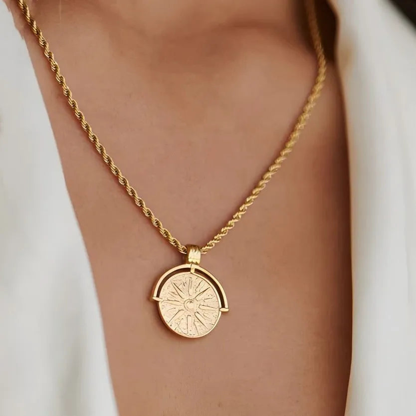 Gold titanium steel necklace with embossed sunflower pendant and geometric star elements on adjustable chain