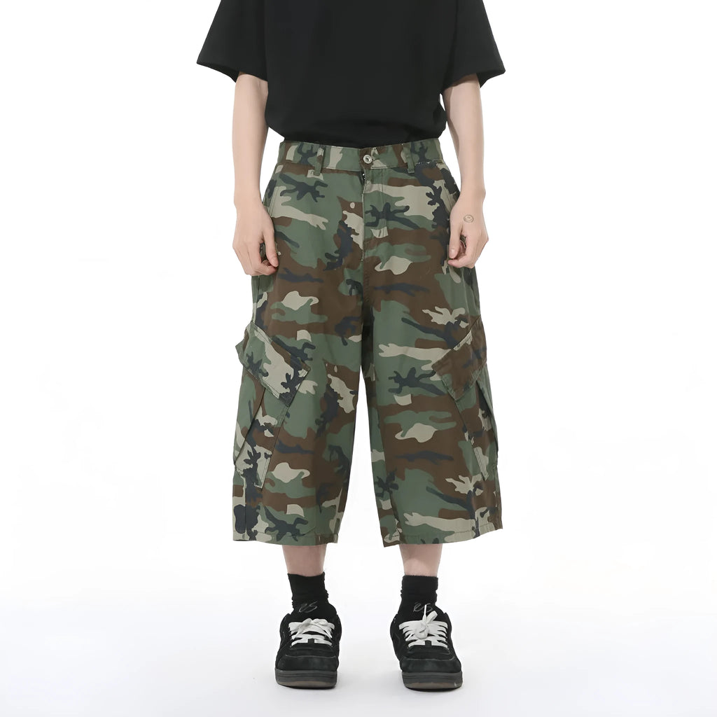 Men's loose fit camouflage cotton jeans with wide legs, cropped length, and a large side pocket.