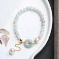 Natural emerald green jade and pearl bracelet with geometric peace buckle closure