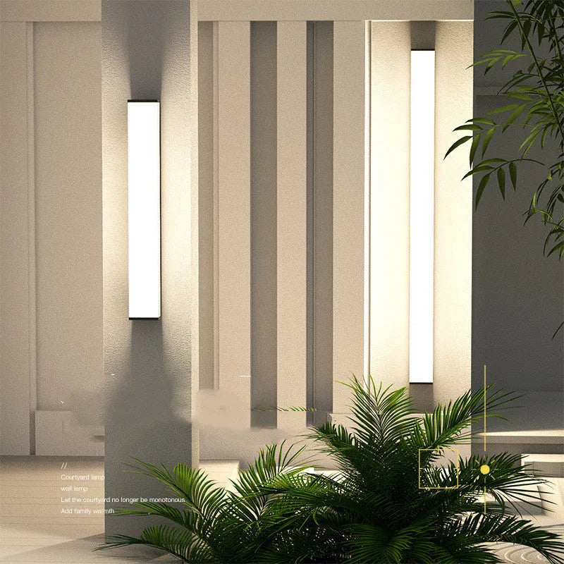Slender stainless steel outdoor wall light with PC shade, 60cm high, for waterproof courtyard and park lighting.