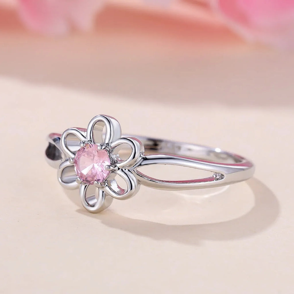 Women's flower-shaped hollow-out copper fashion ring in platinum pink diamond colour.